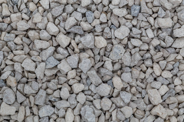istock Dry white limestone ballast flat full frame background. Small gray dusty broken macadam stones texture. 1317411125