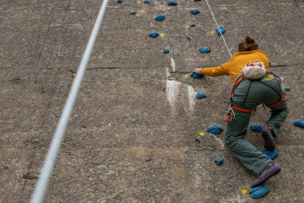 istock Man climbing on concrete dam, Switzerland 1317411278