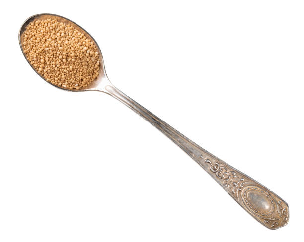 granulated active dry yeast in silver spoon cutout top view of granulated active dry yeast in silver teaspoon cutout on white background tsp stock pictures, royalty-free photos & images