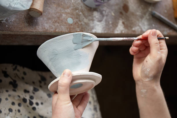 istock Pottery studio The process of creating pottery. The master ceramist works in her studio. workplace of potter 1317412931