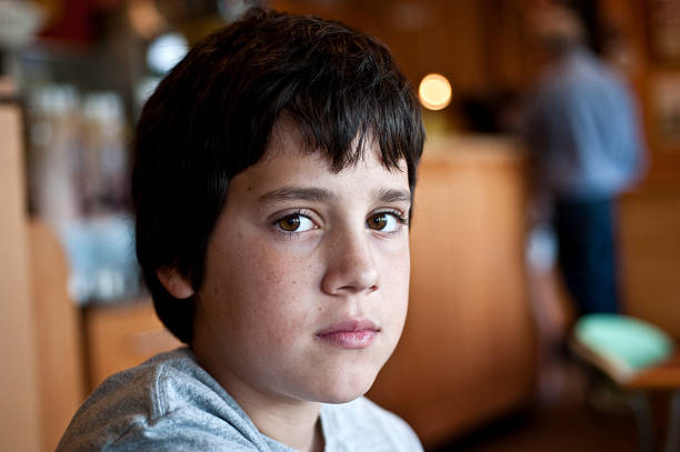 istock A young brunette boy making eye contact with the camera 131741316