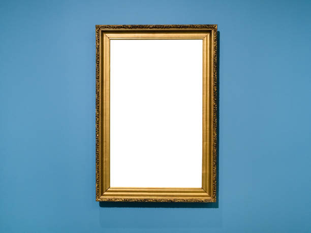 istock vertical golden wood picture frame on blue wall 1317414357