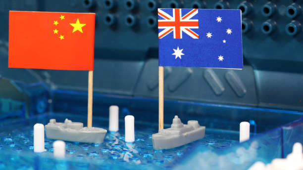 Australia and China relations in south china sea. Naval boats with flags Australian Naval navy ship and a Chinese ship complete with national flags meet on a battleship game board. South China sea, Spratly Islands disputed waters concept sovereignty. australian navy stock pictures, royalty-free photos & images