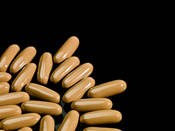 brown cápsulas - gel effect capsule pill vitamin e - fotografias e filmes do acervo