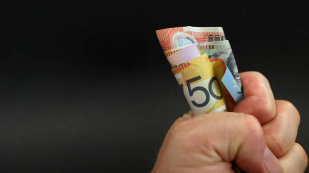 cash grab. fist full of Australian notes A close up of a wad of cash money notes in a tightly clenhed fist. 50 fifty as the main denomination. Gambling payday winning spending saving sales profit concept australian dollar stock pictures, royalty-free photos & images