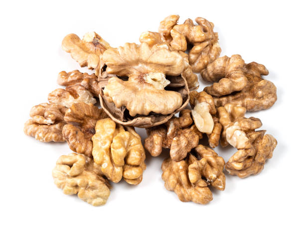 istock shelled and cracked walnuts closeup on white 1317415930