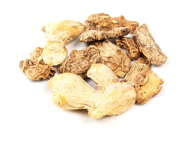 istock handful of dried ginger roots closeup on white 1317415974