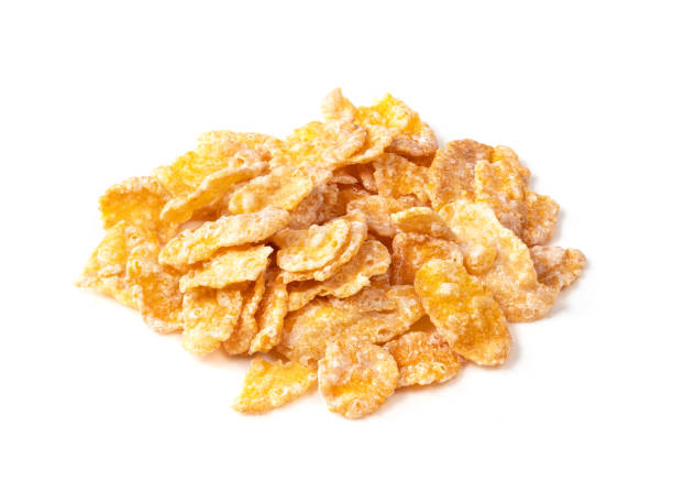 handful of sugar-coated cornflakes on white handful of sugar-coated cornflakes closeup on white background cornflakes stock pictures, royalty-free photos & images