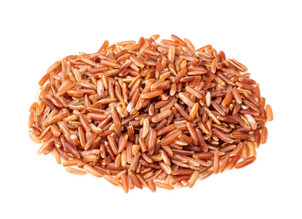 istock handful of raw red rice closeup on white 1317416029