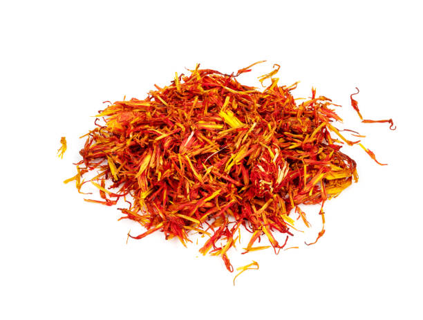 handful of dried safflower petals closeup on white handful of dried safflower petals closeup on white background substitute for saffron stock pictures, royalty-free photos & images