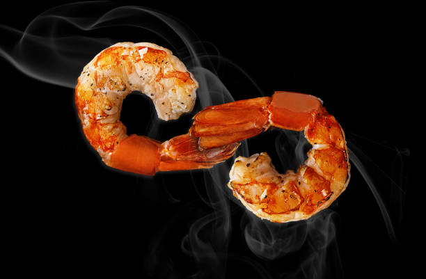 istock Two grilled shrimp tails in shape of infinity sign on black 1317416664