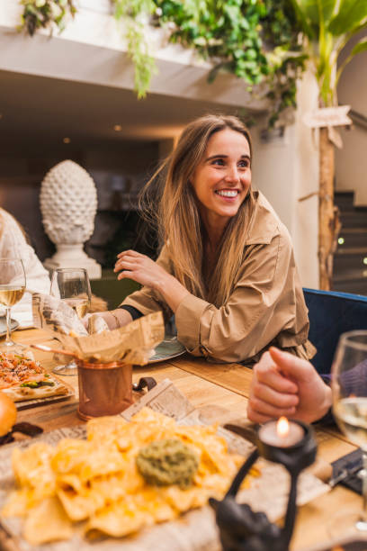 istock Smiling elegant woman at a dinner table conversating 1317416872