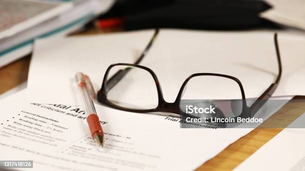 Marking Exams Glasses Red Pen And Exam Paper Stock Photo - Download Image Now - Teacher, Grading, Australia