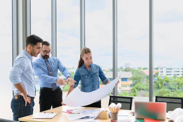 istock Engineers team meeting for architectural project. architects discussing blueprint with construction manager in office worker conference site. Construction Concept 1317418880