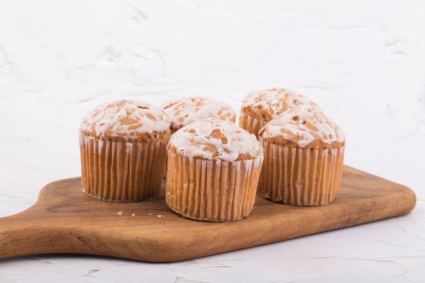 istock delicious fresh muffins on a wooden plate. 1317423543