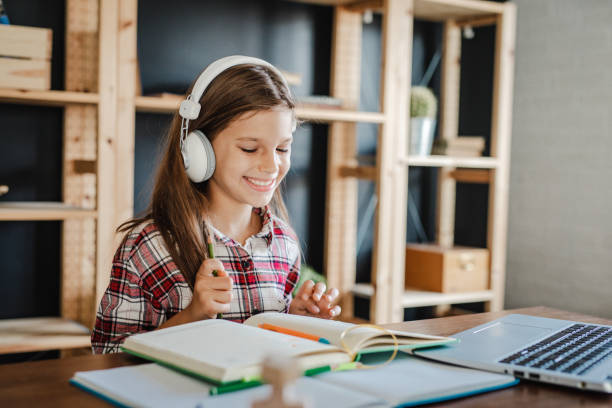 istock Little girl is studying and writing homework 1317424234