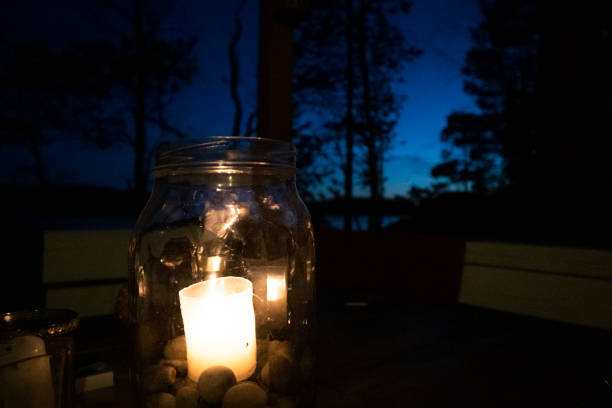 istock Close up candle light in glass on table 1317424630