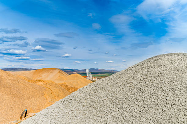 Materials for asphalt hot mix plant - sand and stones, clear blue sky, copy space Materials for asphalt hot mix plant - sand and stones, clear blue sky, copy space. The photo is taken in asphalt factory near Sofia, Bulgaria with Sony A7III camera. slag heap stock pictures, royalty-free photos & images