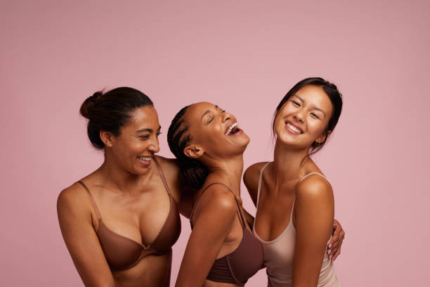 Natural beauties smiling together Group of cheerful women in lingerie. Natural beauties smiling in underwear. lingerie stock pictures, royalty-free photos & images