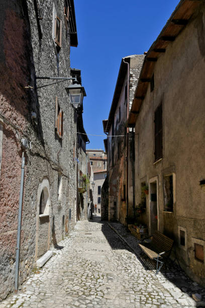 The old town of Sermoneta, Italy. Sermoneta, Italy, 05/10/2021. a narrow street between old stone buildings of a medieval town in the Lazio region. village lazio photography sermoneta stock pictures, royalty-free photos & images