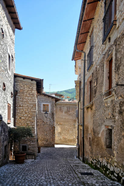 The old town of Sermoneta, Italy. Sermoneta, Italy, 05/10/2021. a narrow street between old stone buildings of a medieval town in the Lazio region. village lazio photography sermoneta stock pictures, royalty-free photos & images