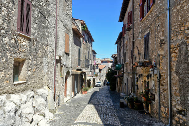 The old town of Sermoneta, Italy. Sermoneta, Italy, 05/10/2021. a narrow street between old stone buildings of a medieval town in the Lazio region. village lazio photography sermoneta stock pictures, royalty-free photos & images