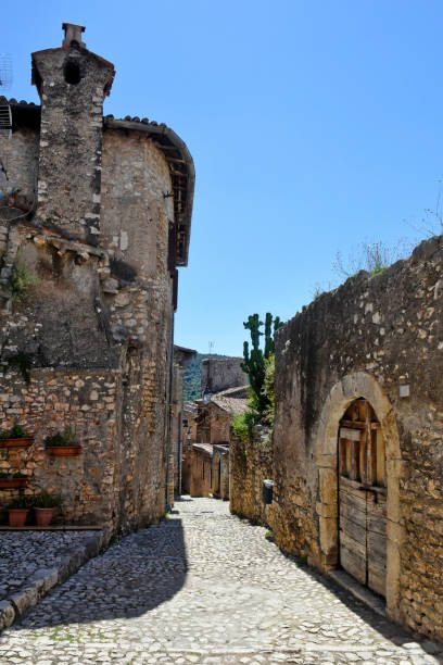 The old town of Sermoneta, Italy. Sermoneta, Italy, 05/10/2021. a narrow street between old stone buildings of a medieval town in the Lazio region. village lazio photography sermoneta stock pictures, royalty-free photos & images