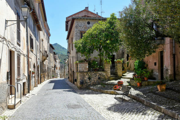 The old town of Sermoneta, Italy. Sermoneta, Italy, 05/10/2021. a narrow street between old stone buildings of a medieval town in the Lazio region. village lazio photography sermoneta stock pictures, royalty-free photos & images