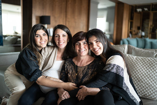 Portrait of mother with daughters at home