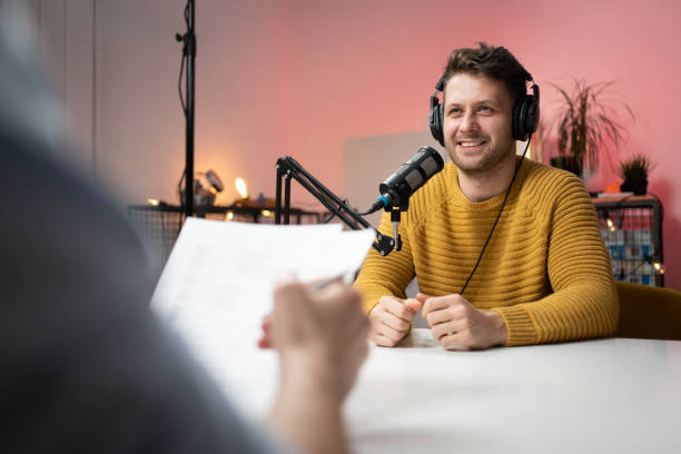 istock Smiling young man as a commentator on a podcast 1317428333