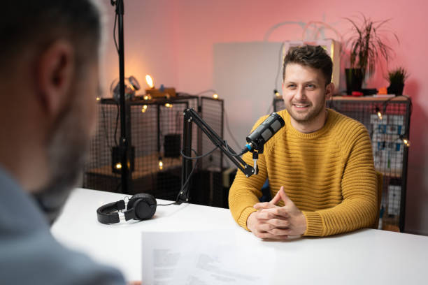 istock Smiling young man as a commentator on  a podcast 1317428357