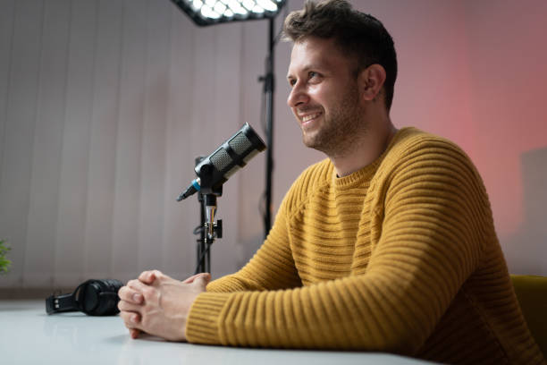 istock Smiling young mane sitting in the studio, recording show 1317428358