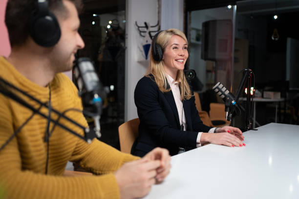 istock Smiling woman talking on a podcast 1317428443