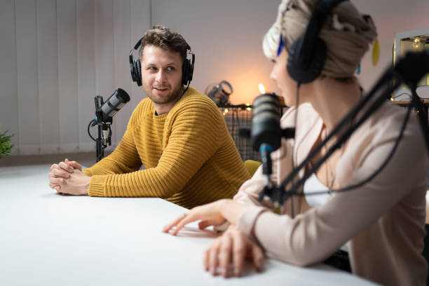 istock Young man and woman talking together on a podcast 1317428459