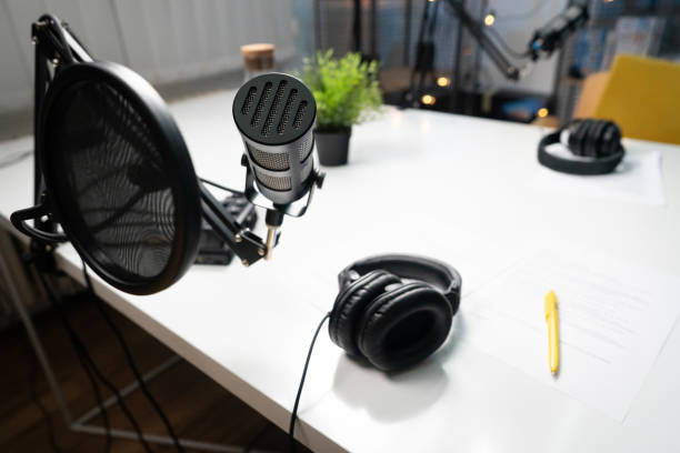 istock High-angle view of a microphone and headphones in a podcast studio 1317428490