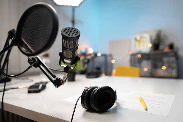istock Microphone and headphones in a podcast studio 1317428526
