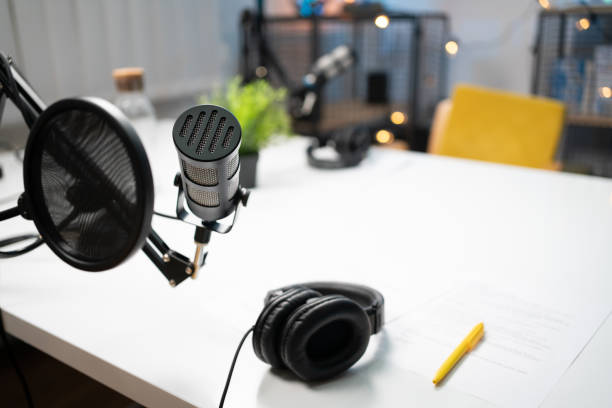 istock High angle view of a headphones and a microphone in a recording studio 1317428534