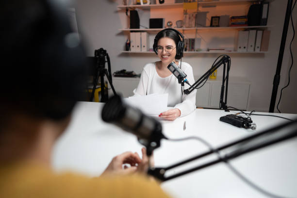 istock Smiling female radio host talking with her guest 1317428734