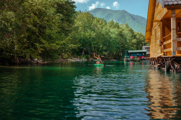 istock Paddle boarding woman on beautiful lake 1317430713