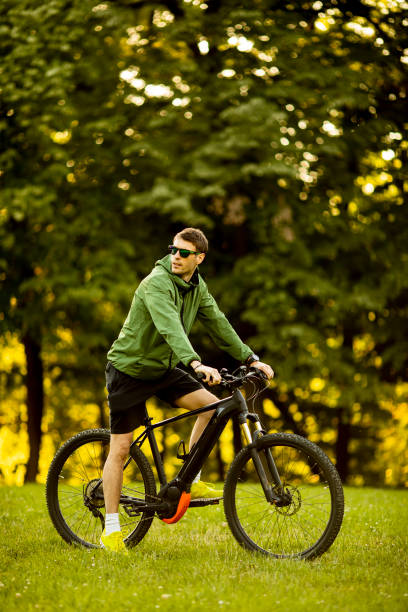 istock Young man riding ebike in the park 1317431743