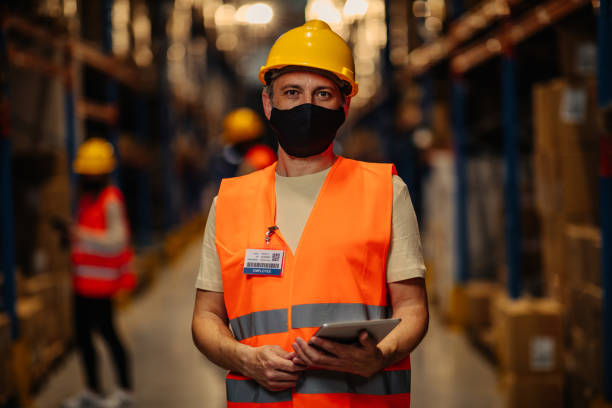 istock Warehouse worker with face masks during and after coronavirus pandemic 1317433026
