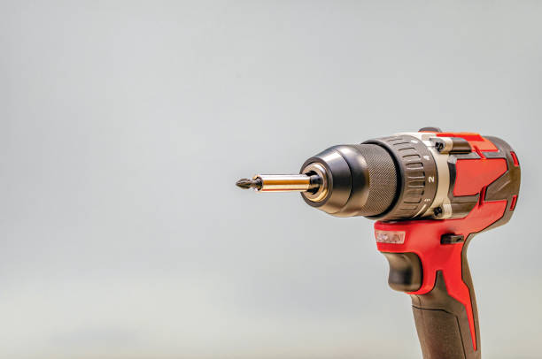istock Red cordless drill on a black background. Screw tightening tool 1317434129