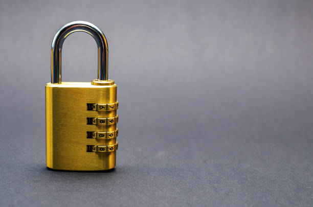 istock Close-up combination lock with chrome numerals on black background. 1317434160