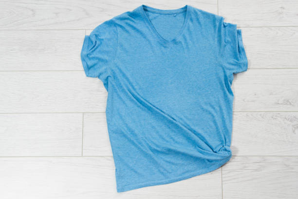 istock Blue t-shirt mock up top view, blue shirt copy space 1317435610