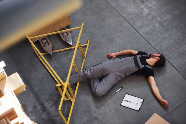 istock Warehouse worker after an accident in the storage. Man in uniform lying down on the ground 1317435720
