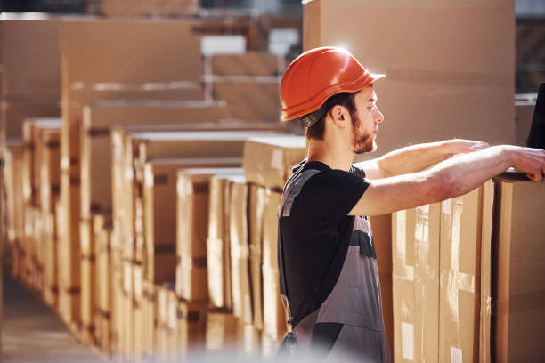 istock Young storage worker in warehouse in uniform busy with some work 1317435929