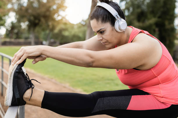 istock Plus size woman doing stretching day routine outdoor at city park - Focus on face 1317437704