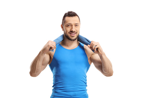 Man in sportswear holding a towel aroung his neck isoloated on white background