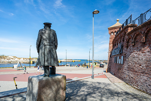 Kolobrzeg, Poland, May 10 2021: Harbor in Kolobrzeg, view of the port exit and the old, brick lighthouse. Kolobrzeg, formerly Kolberg, is one of the most famous Polish health resorts and a holiday resort on the Baltic Sea.