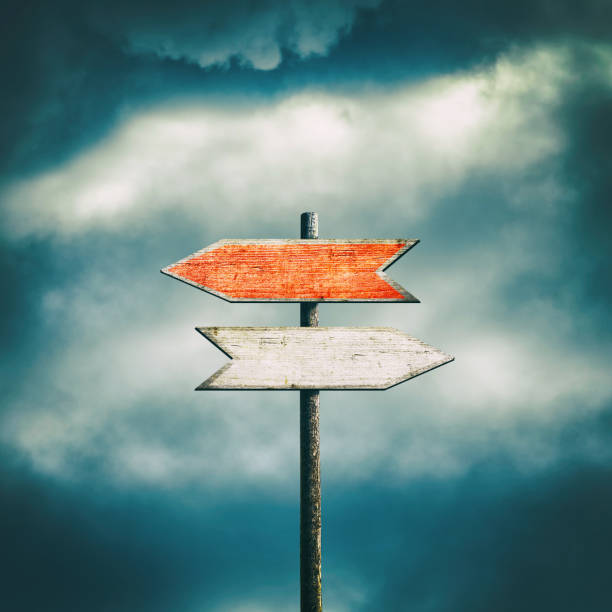 Wooden Sign with arrows pointing in different directions. Path selection concept. Making the right decision. The right direction. Square orientation. Close-up. Business. Lifestyle.
